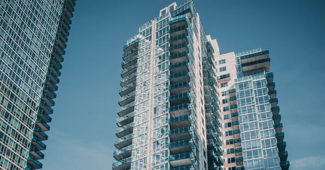 Glass apartment towers viewed from street level in New York.